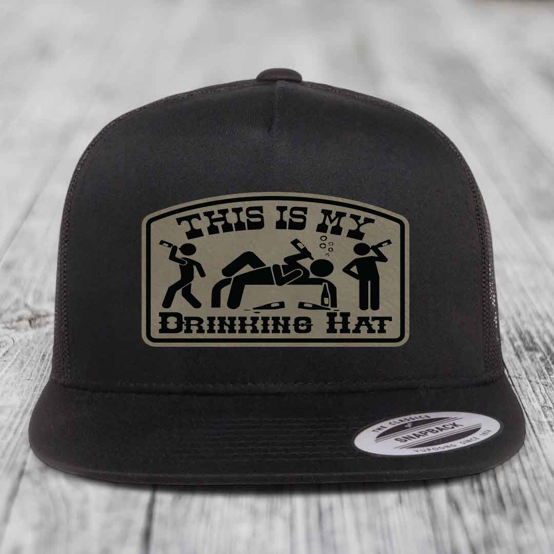 Black snapback hat with beige patch reading &