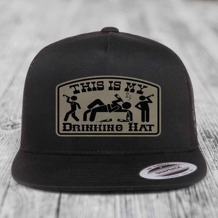 Black snapback hat with beige patch reading &