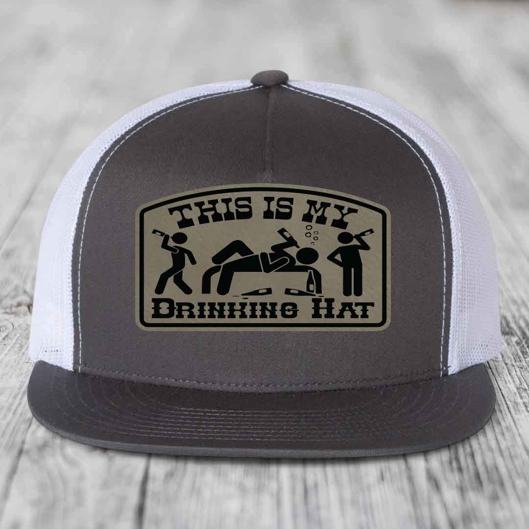 Grey trucker hat with beige leather patch reading &