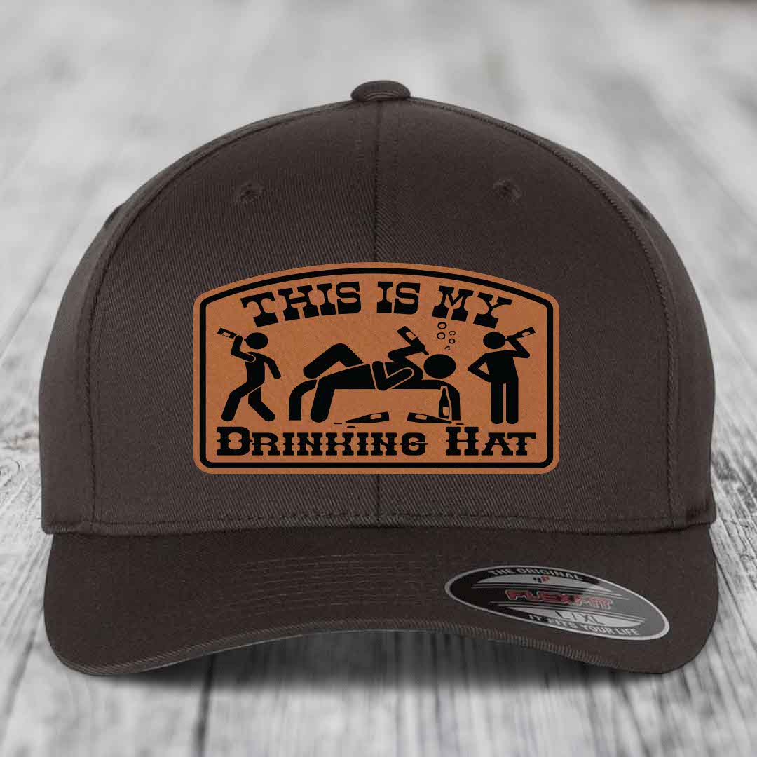 Dark brown baseball cap with tan leather patch reading &