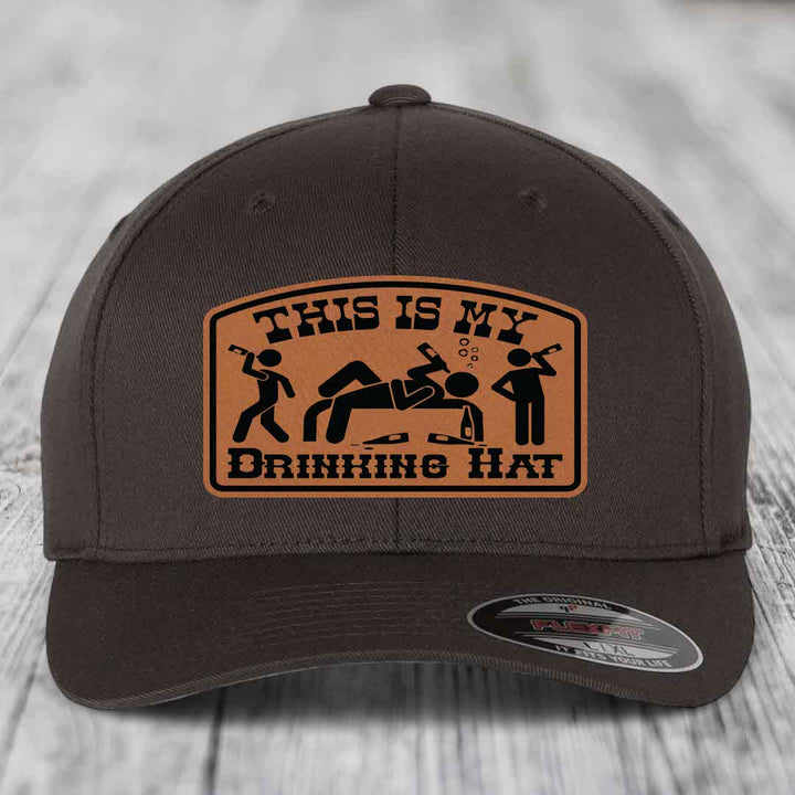 Dark brown baseball cap with tan leather patch reading &