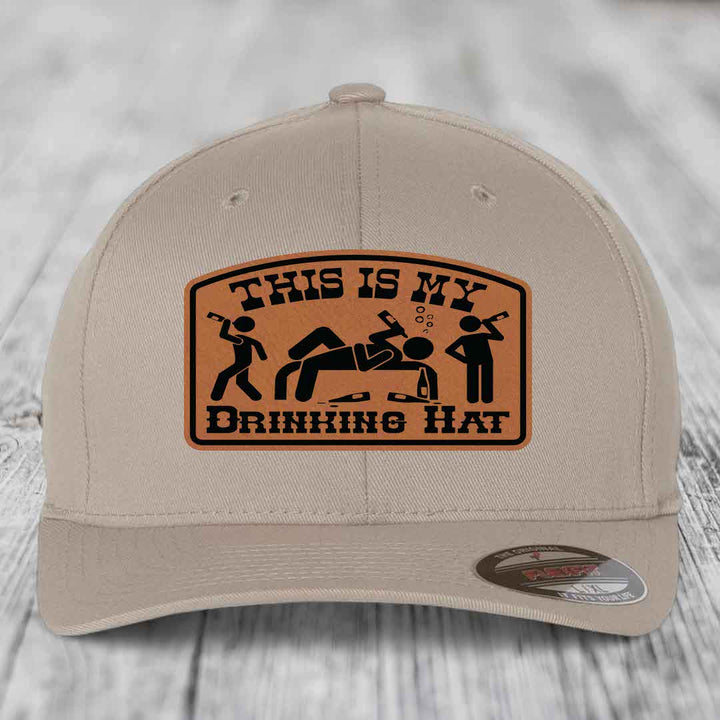 Beige baseball cap with brown leatherette patch reading &