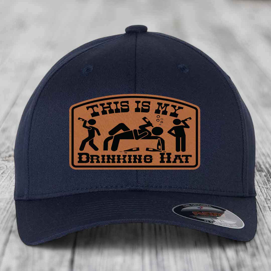 Dark blue baseball cap with a tan leatherette patch reading &