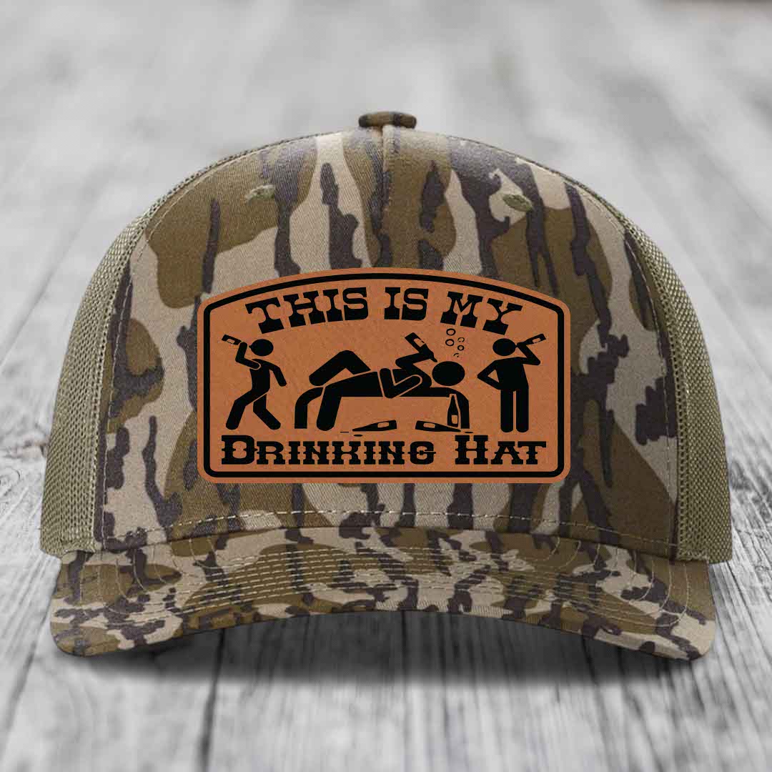Camouflage trucker hat with brown leather patch reading &