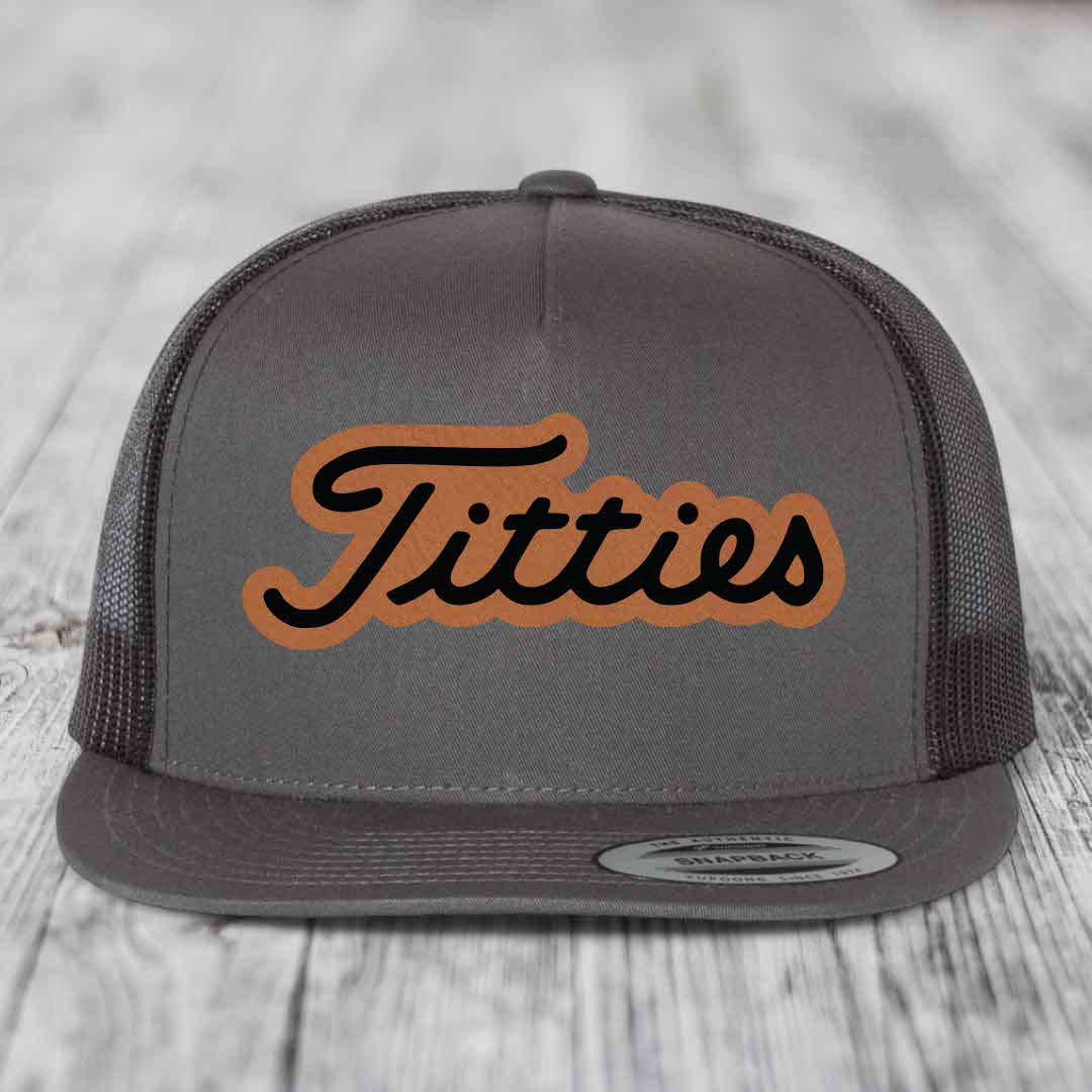 Grey trucker hat with brown leatherette patch featuring black cursive &