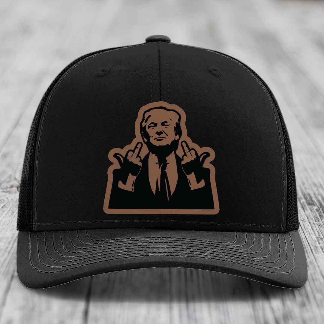 Black trucker hat with brown leather patch of man making rude hand gesture.