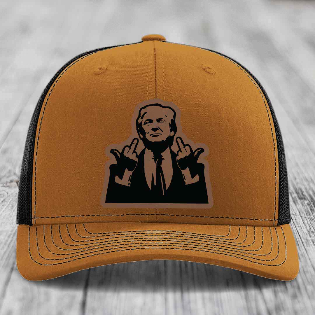 Tan trucker hat with black mesh back and embroidered patch of a man making hand gestures.
