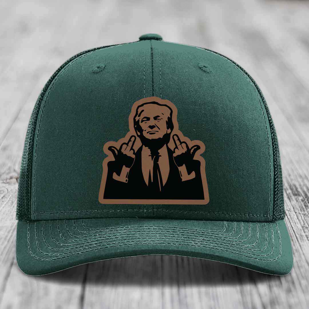 Green trucker hat with a brown and black leatherette patch of a man giving two middle fingers.