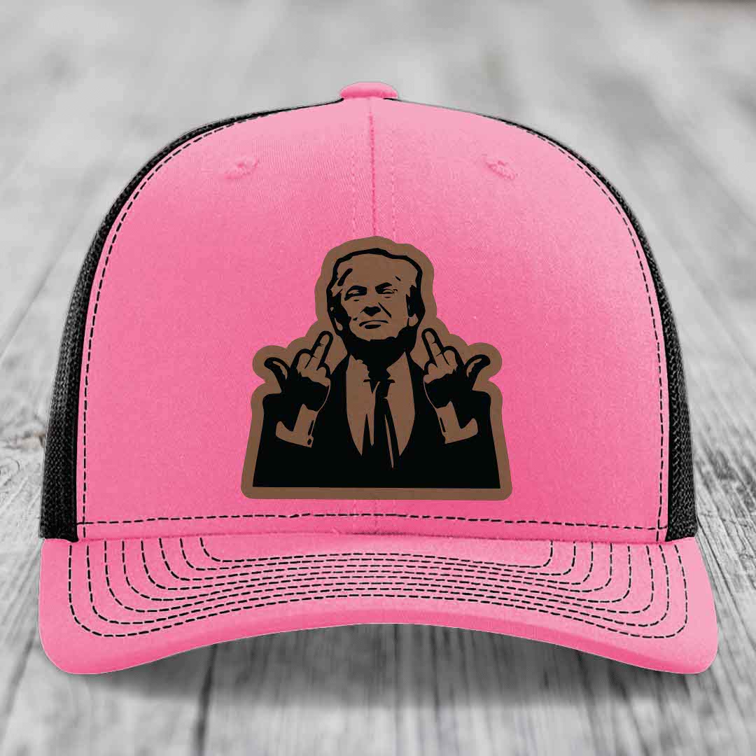 Pink trucker hat with black mesh back and a brown leather patch of a man making rude hand gestures.