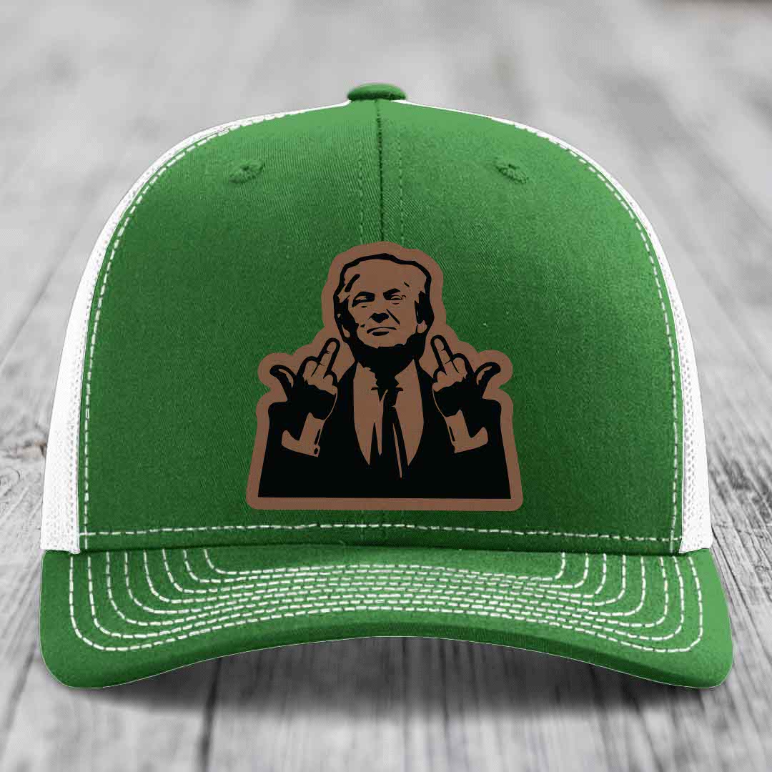Green trucker hat with white mesh back and stitching, featuring a brown leatherette patch of a man making hand gestures.