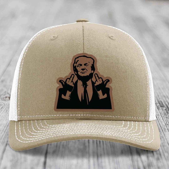Tan trucker hat with white mesh back and embroidered patch of man making hand gestures.
