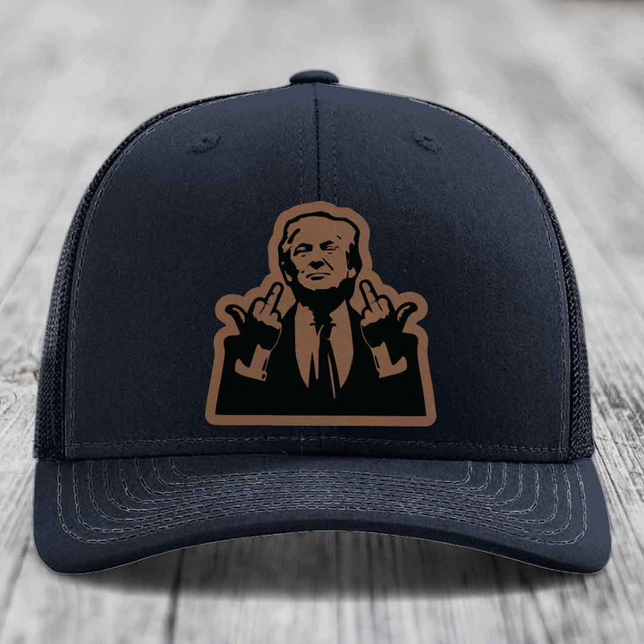 Black trucker hat with brown leather patch of man making middle finger gesture.