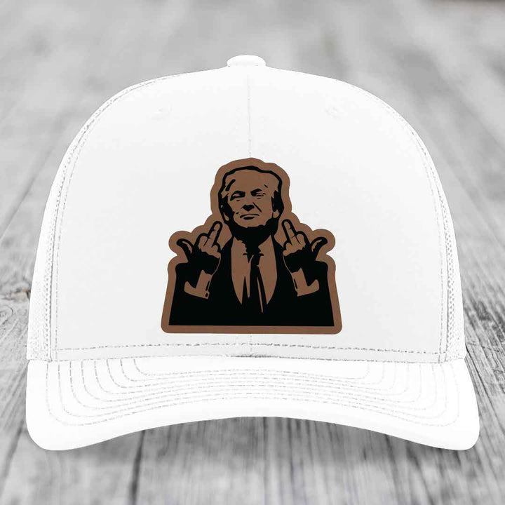 White trucker hat with brown leather patch of man making middle finger gesture.