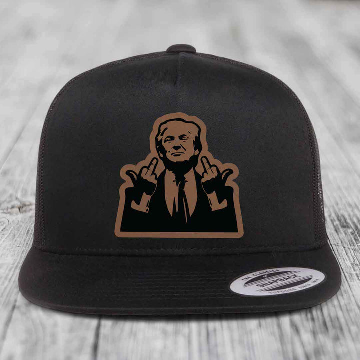 Black snapback hat with brown and black graphic patch of a man making hand gestures.