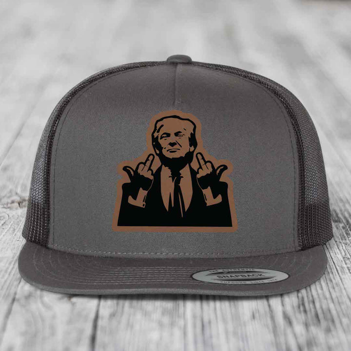 Grey trucker hat with brown leather patch of man making rude hand gesture.