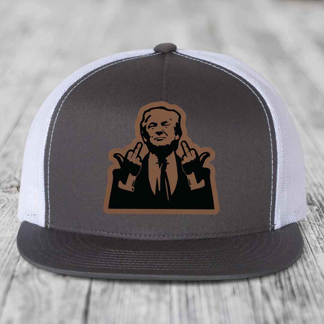 Grey and white trucker hat with a brown leather patch of a man giving two middle fingers.