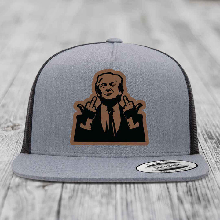 Grey trucker hat with black and brown leather patch of man making rude hand gestures.