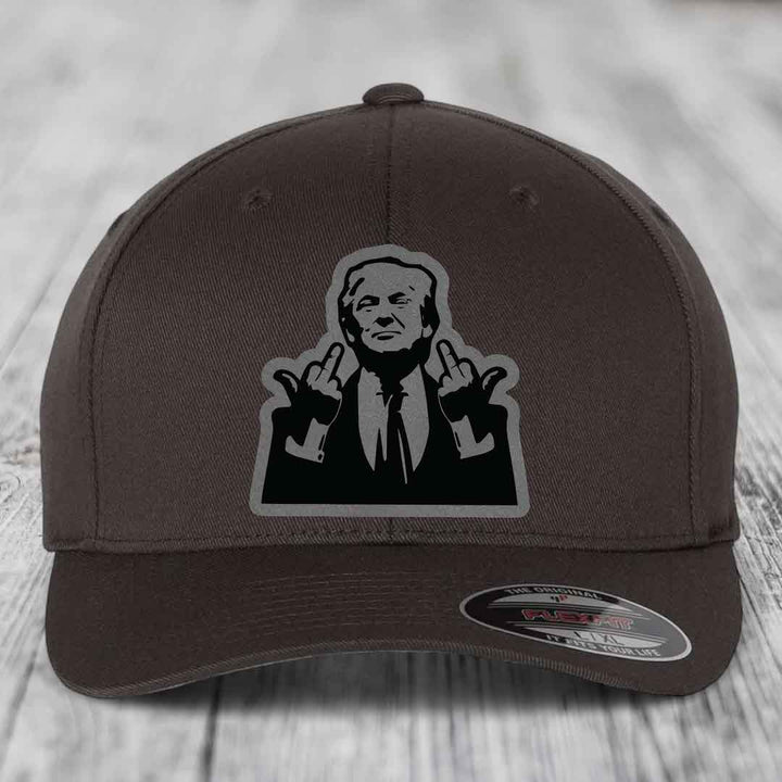 Dark brown Flexfit hat with a black and grey patch of a man making rude hand gestures.