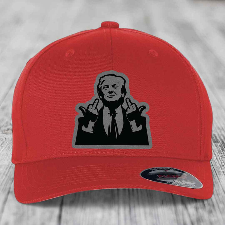 Red baseball cap with black and grey patch of a man making rude hand gestures.
