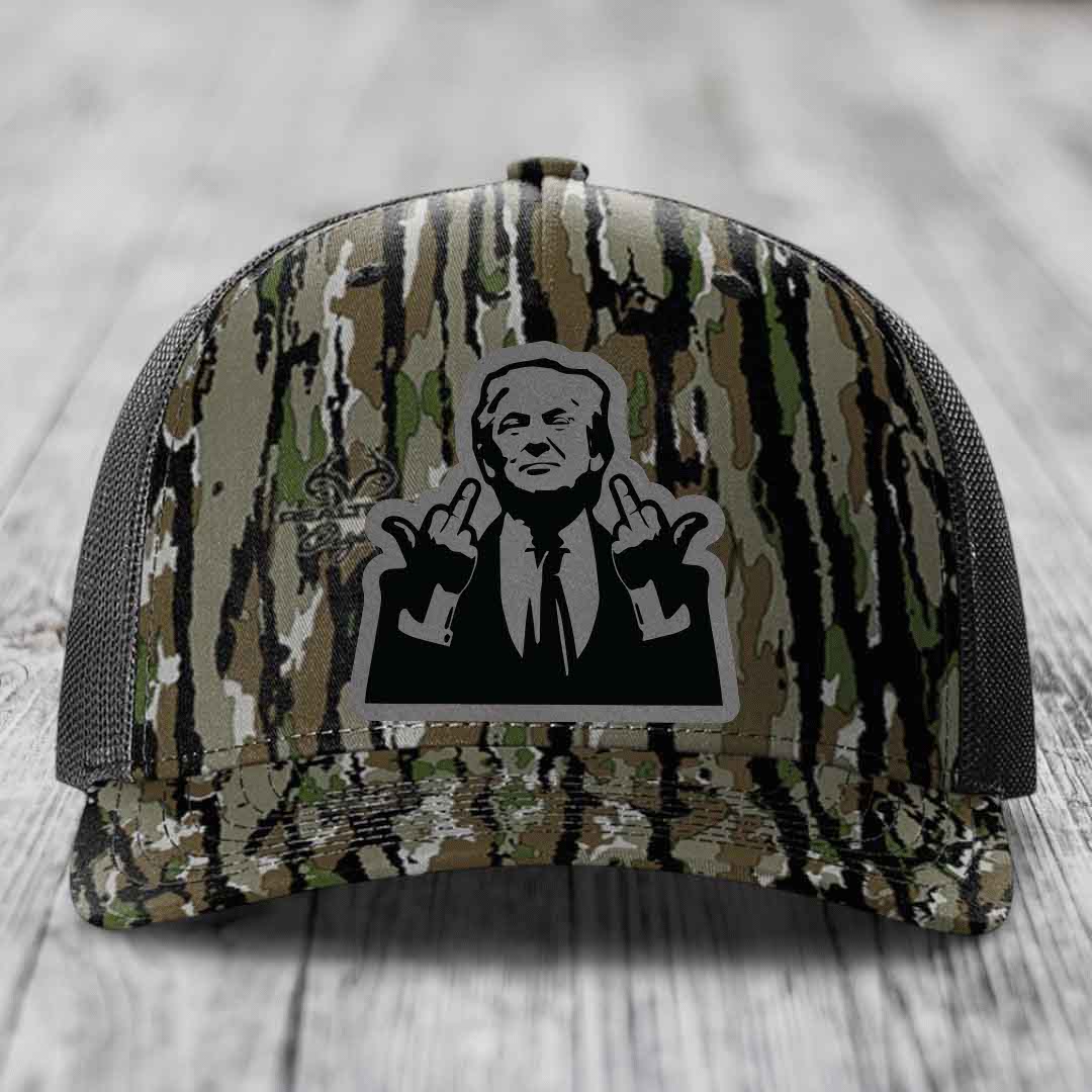Camouflage trucker hat with black and grey patch of man making rude hand gesture.