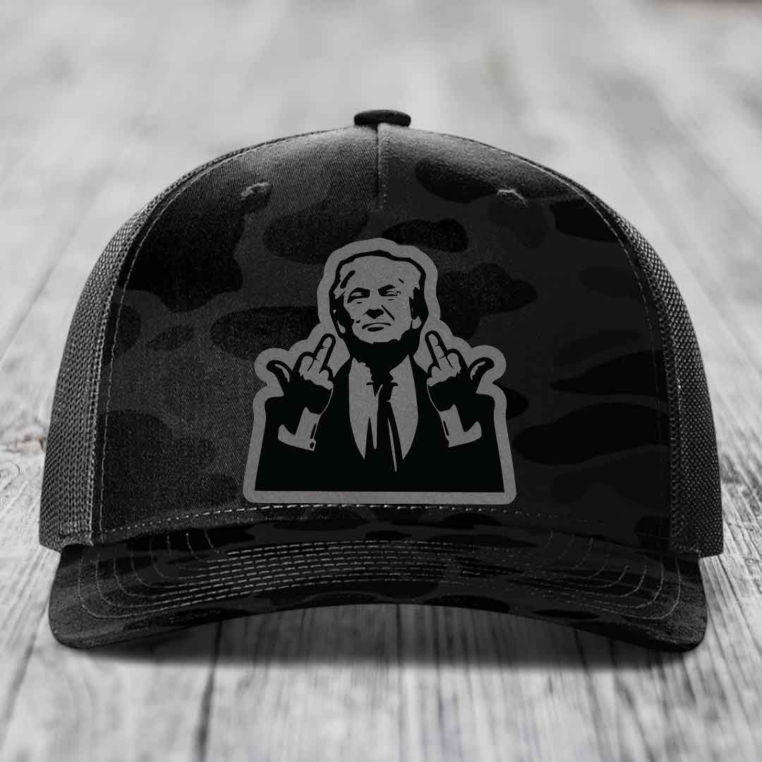 Black camouflage trucker hat with a graphic patch of a man making hand gestures.