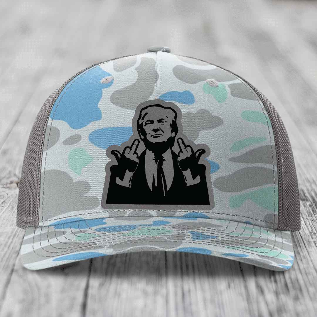 Camouflage trucker hat with black silhouette patch of man giving middle finger gesture.