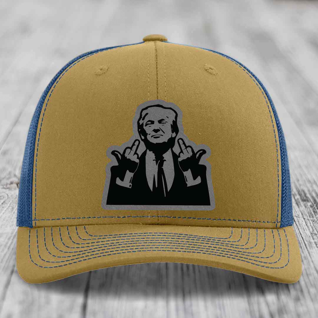 Two-tone trucker hat with tan front and blue mesh back, featuring a black-and-grey graphic patch of a man making hand gestures.