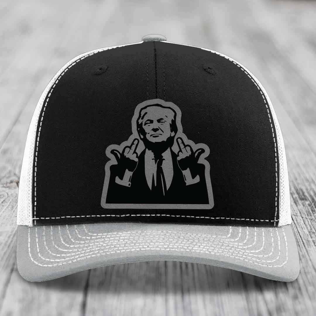 Black and white trucker hat with graphic patch of man making hand gestures.