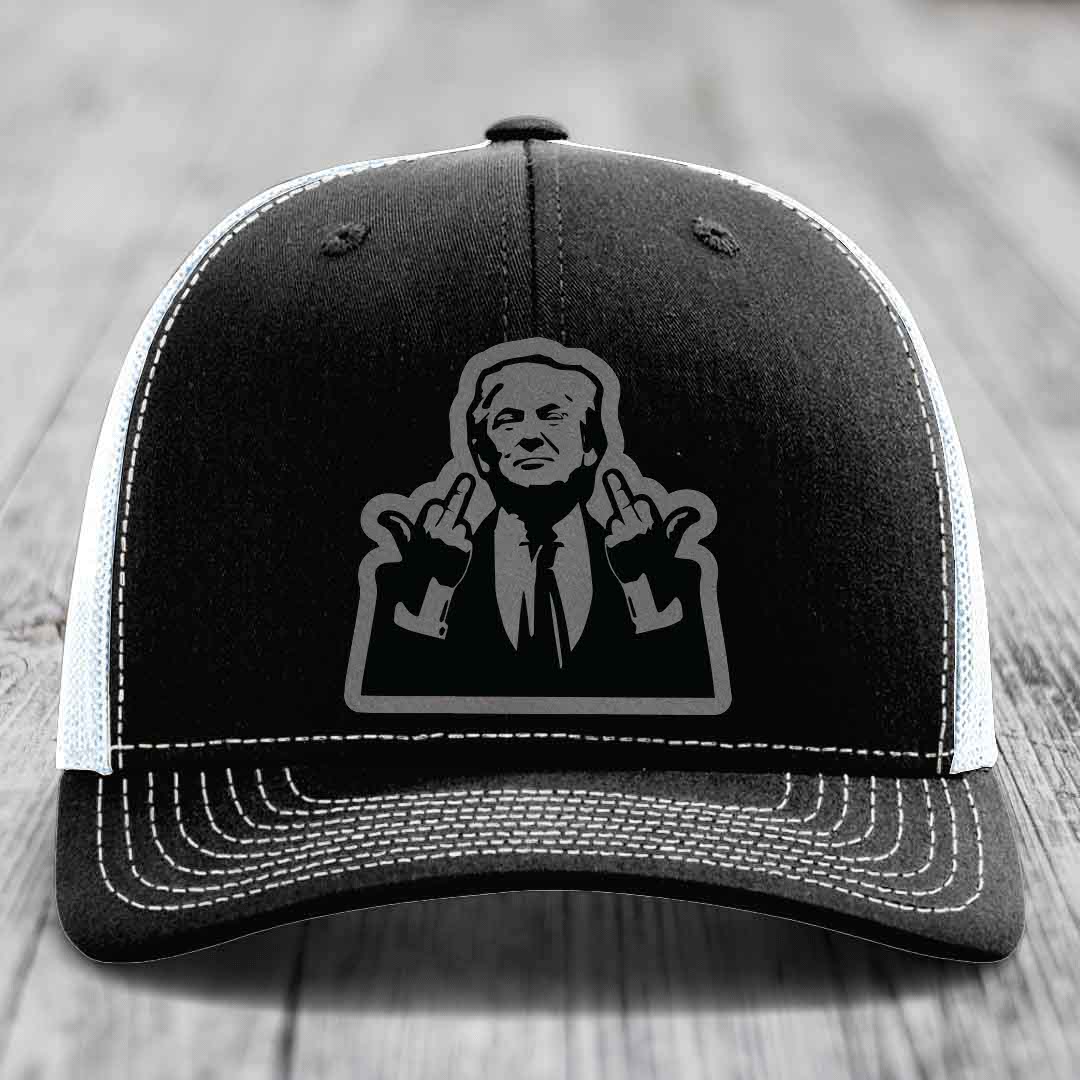 Black trucker hat with white stitching and a graphic patch of a man making hand gestures.