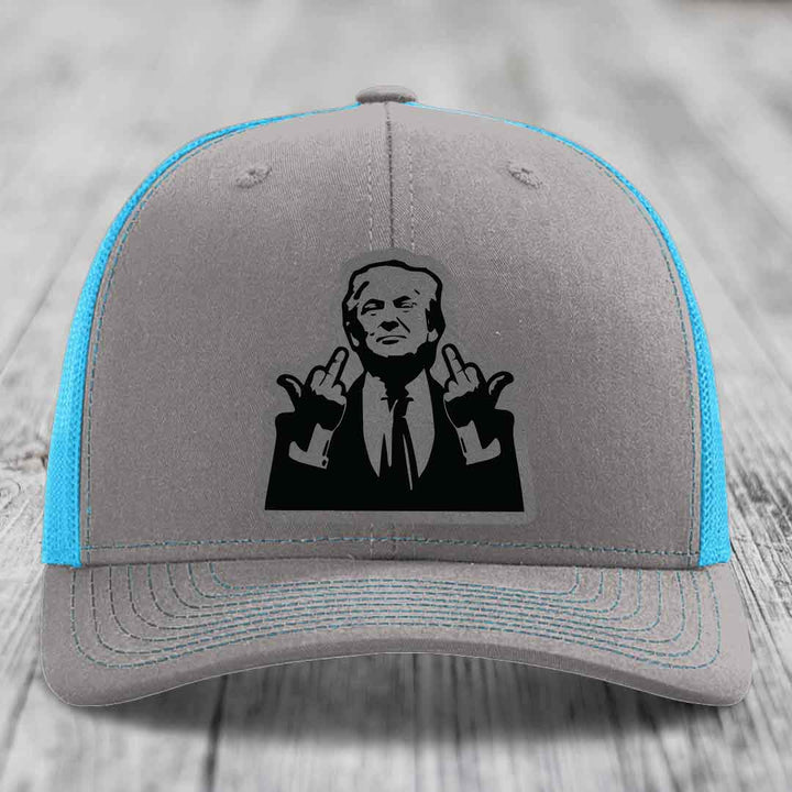 Grey trucker hat with blue mesh sides and a black leather patch of a man making hand gestures.