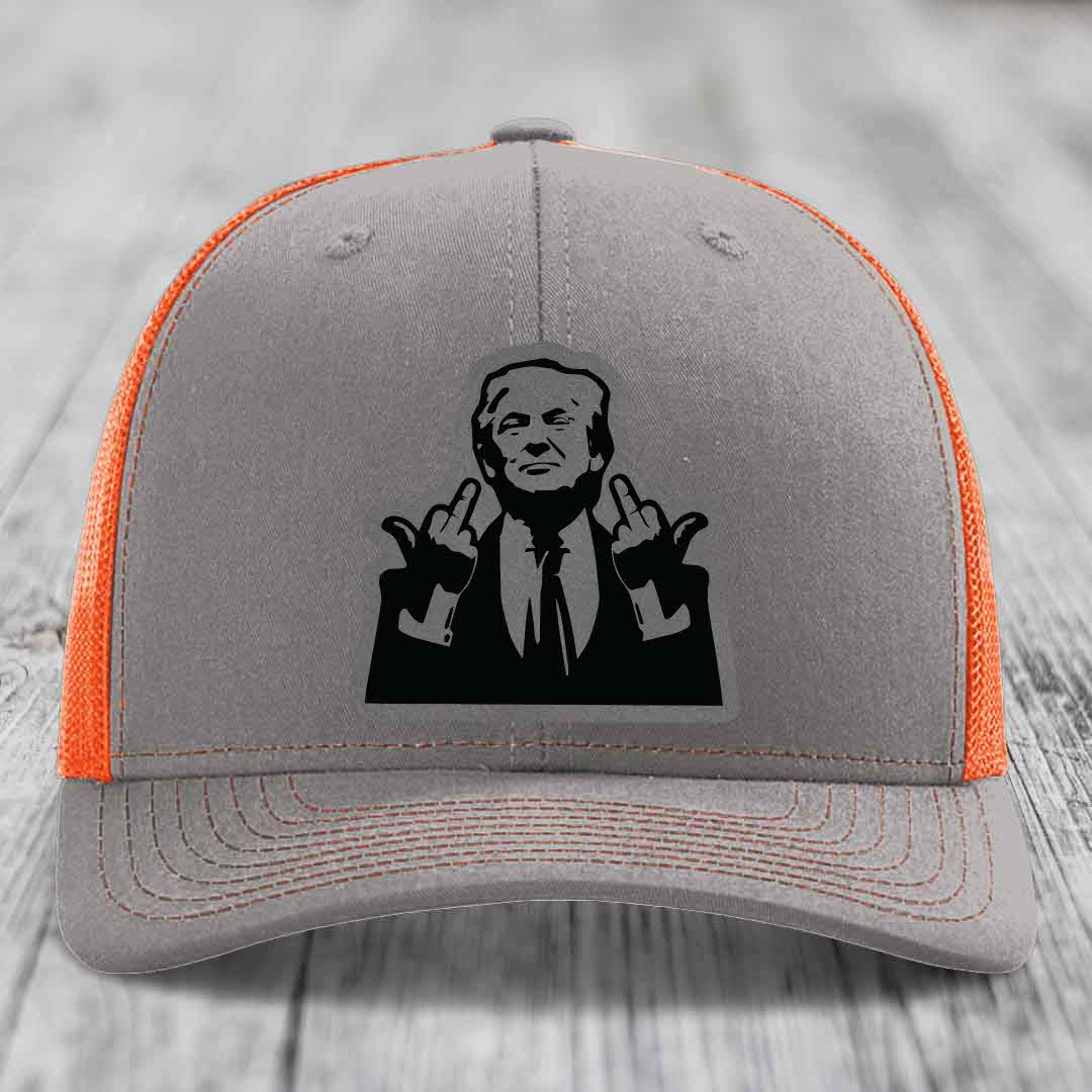 Grey trucker hat with orange mesh back and black patch of man making hand gestures.