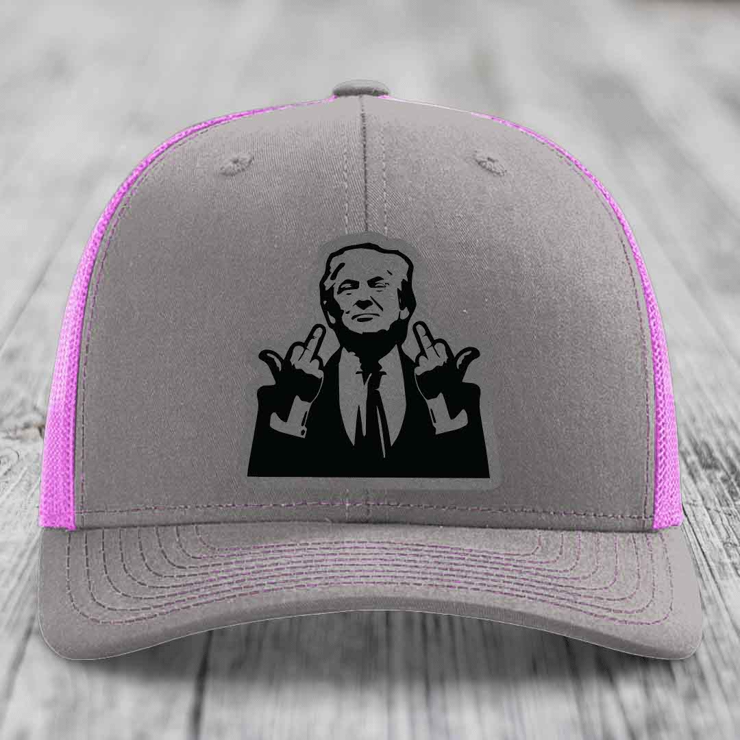 Grey trucker hat with pink mesh sides and a black graphic patch of a man making hand gestures.