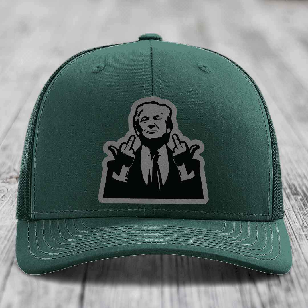 Green trucker hat with black and grey patch of man making rude hand gesture.