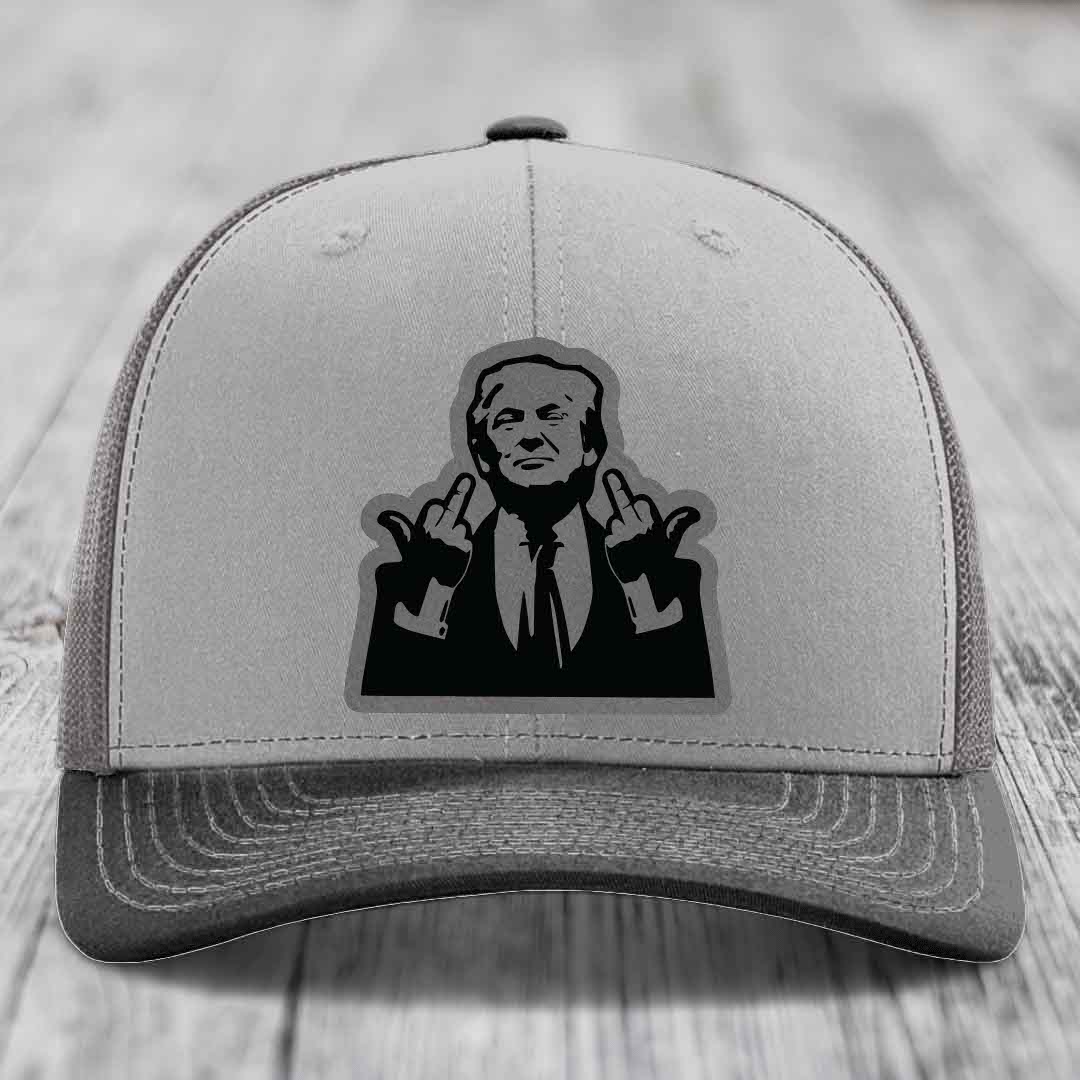 Grey trucker hat with black leatherette patch of man giving middle finger gesture.