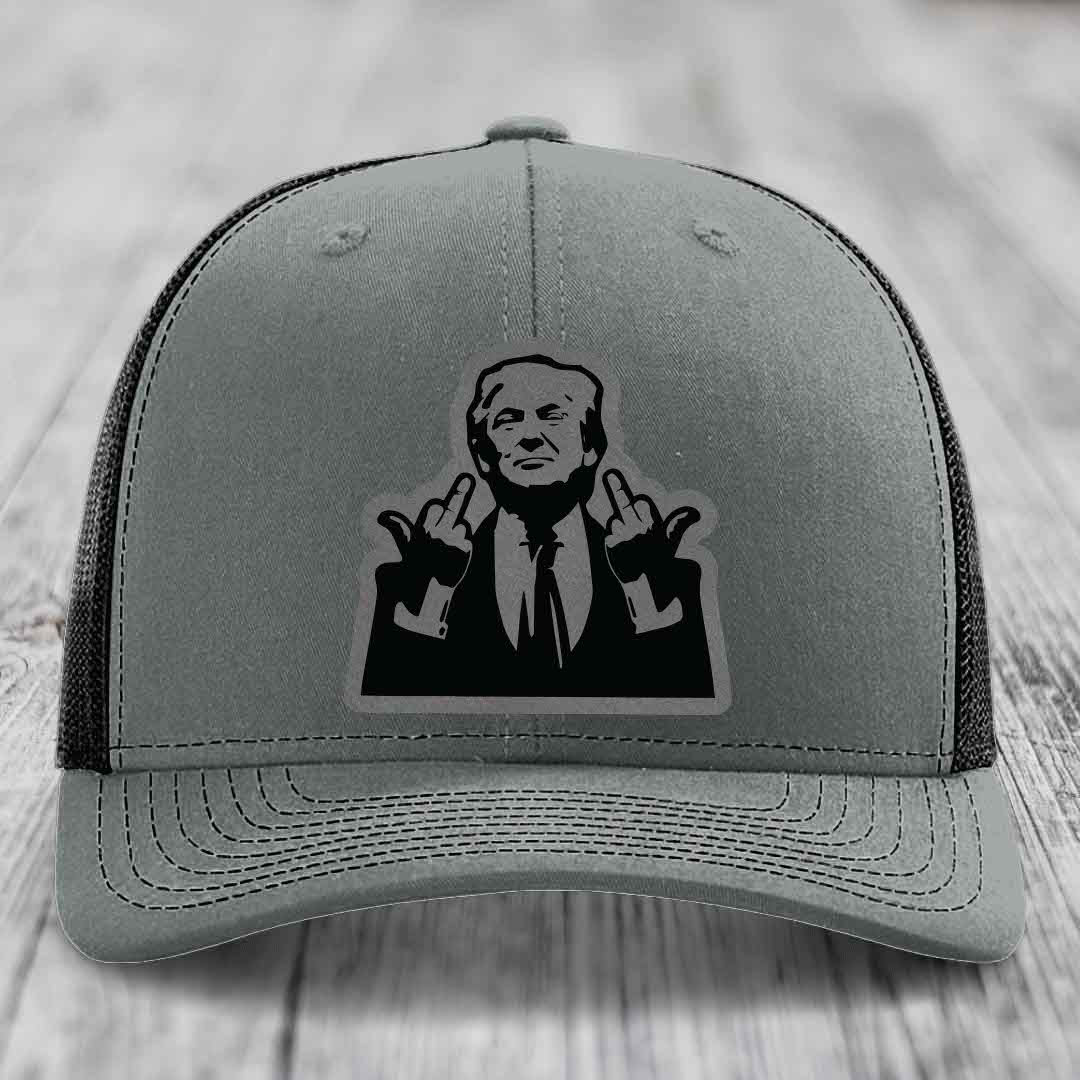 Grey trucker hat with black mesh back and a black leather patch of a man making hand gestures.