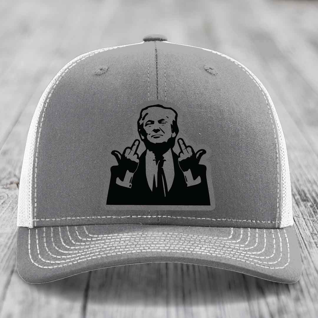 Grey trucker hat with white mesh back and black patch of man giving middle finger gesture.