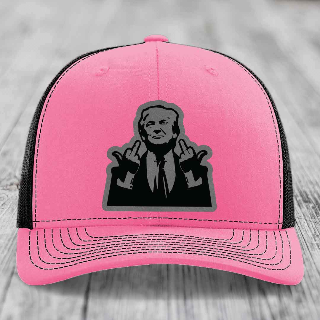 Pink trucker hat with black mesh back and a black graphic patch of a man making hand gestures.