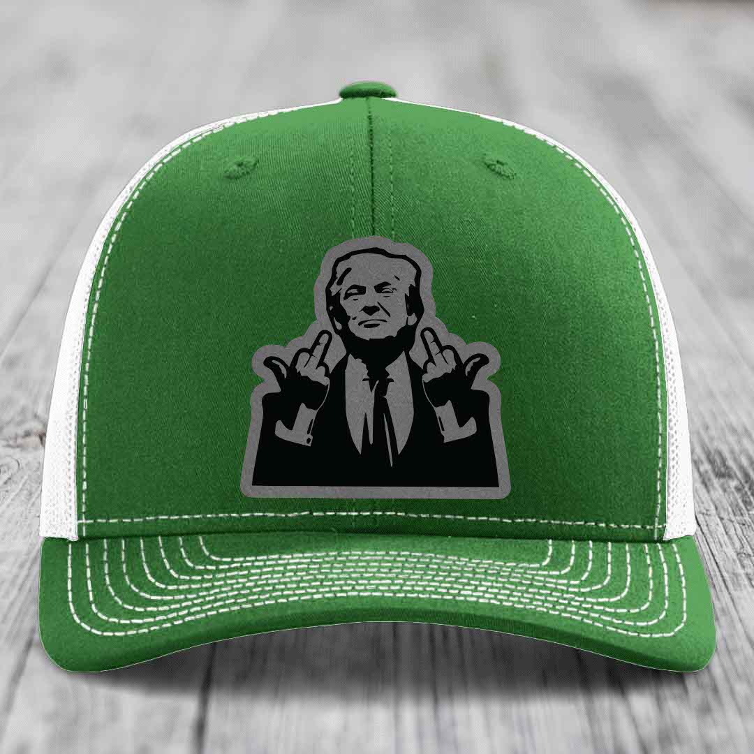 Green trucker hat with white mesh back and stitching, featuring a black-and-grey graphic patch of a man making hand gestures.