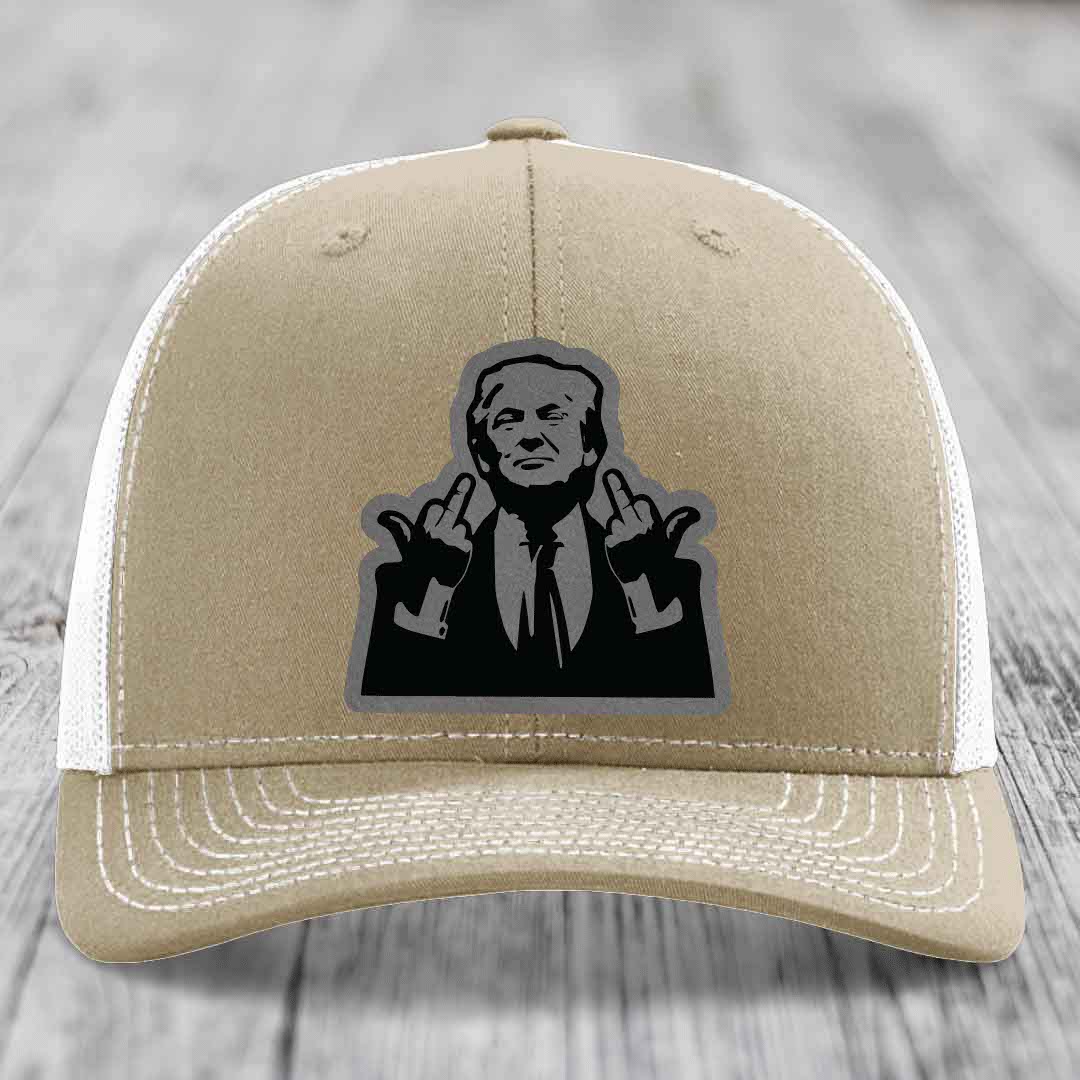 Tan trucker hat with black and grey patch of man making rude hand gesture