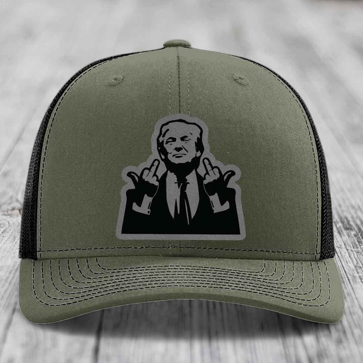 Olive green trucker hat with black mesh back and a black-and-white graphic patch of a man making hand gestures.
