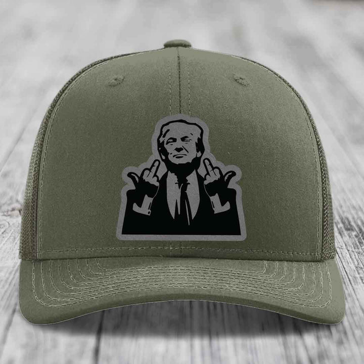 Olive green trucker hat with black and gray patch of a man making rude hand gestures.