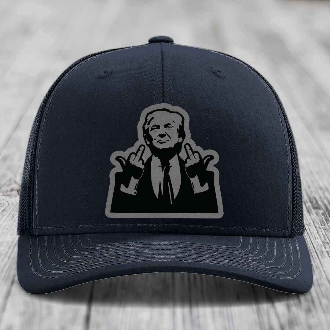 Black trucker hat with gray stitched details and a black-and-gray graphic patch of a man making hand gestures.