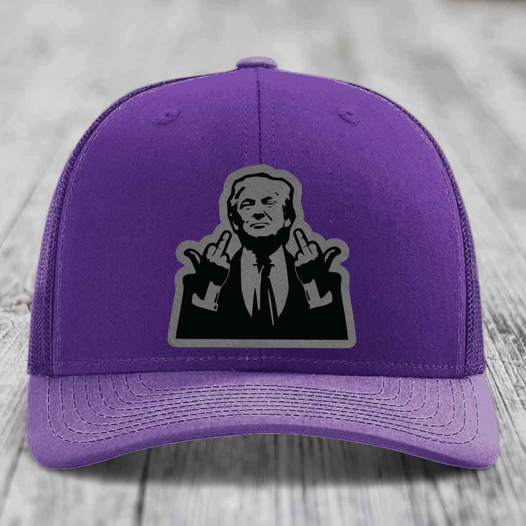 Purple trucker hat with black and grey patch of a man making rude hand gestures.