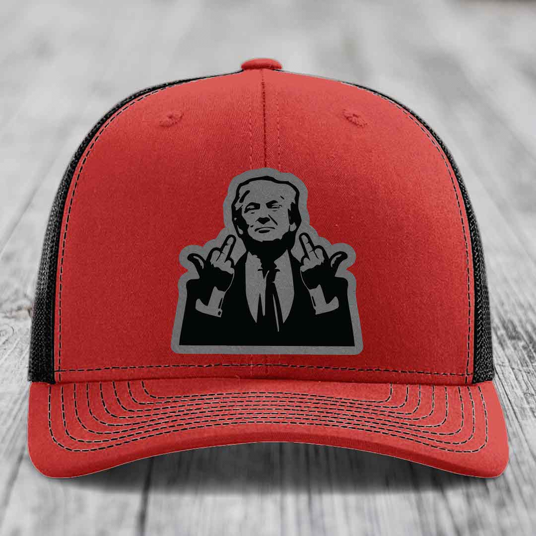 Red trucker hat with black mesh back and gray outline patch of a man making hand gestures.