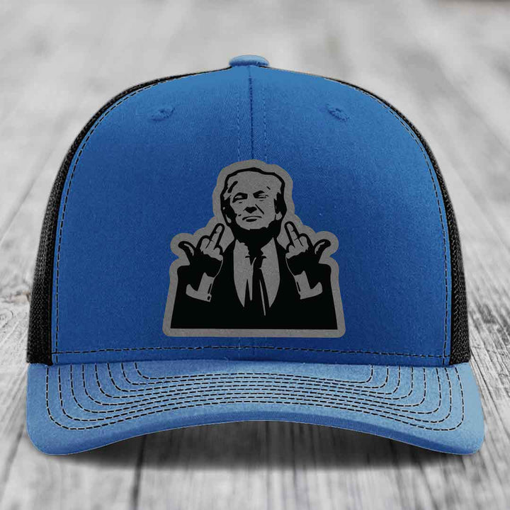 Blue trucker hat with black mesh back and gray outline patch of a man making hand gestures.