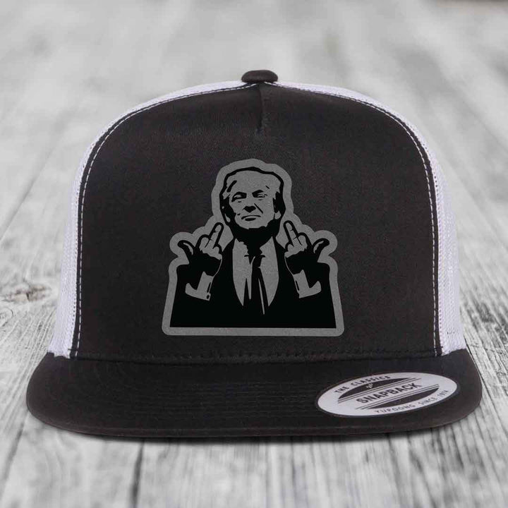 Black and white trucker hat with a graphic patch of a man making hand gestures.