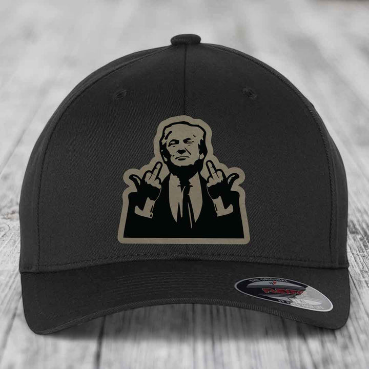 Black baseball cap with beige and black graphic patch of a man making hand gestures.