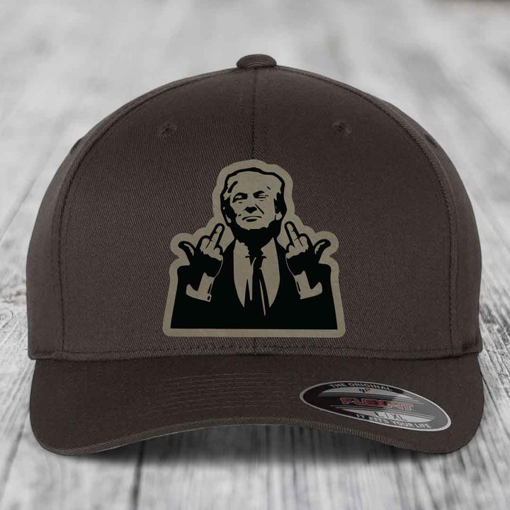 Dark brown Flexfit hat with a black and beige patch of a man making rude hand gestures.