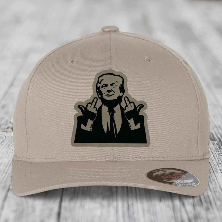 Beige baseball cap with black silhouette patch of man making rude hand gestures.