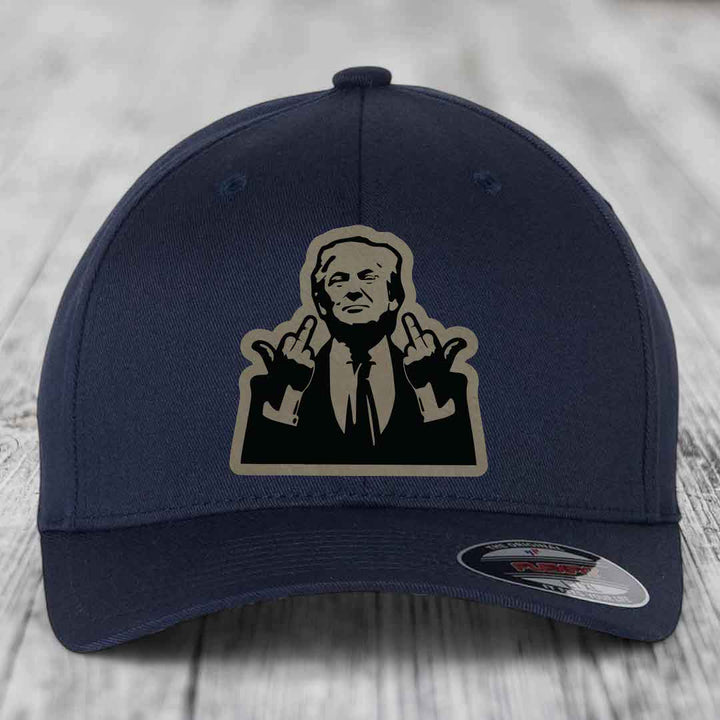 Dark blue baseball cap with a beige and black graphic patch of a man making hand gestures.